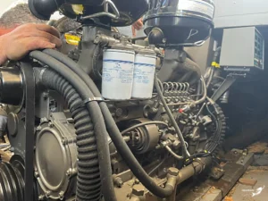 Close-up detail of a Yuchai marine diesel engine installation showing fuel filtration and cooling systems by Nafpaktos Marine.